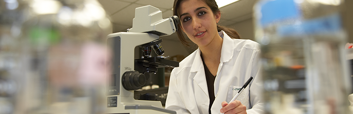 student at microscope